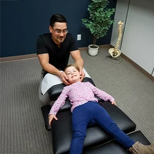 Chiropractor Leavenworth KS Dennis Lindsay Adjusting Child