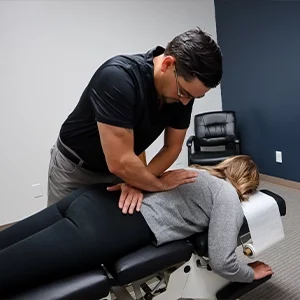 Chiropractor Leavenworth KS Dennis Lindsay Adjusting Patients Spine